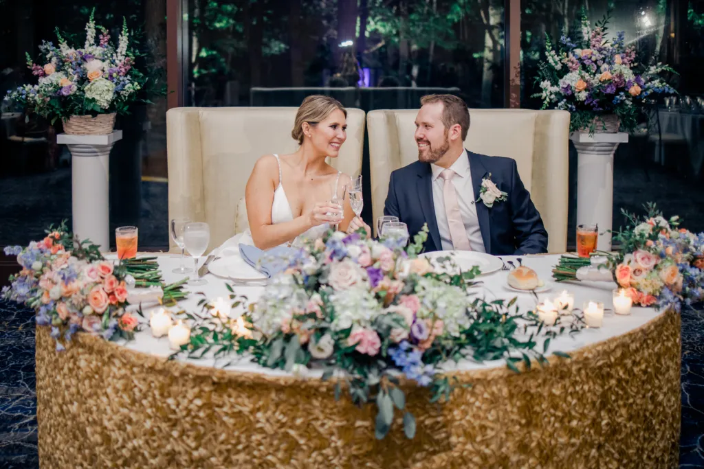Bride and groom sitting on a table