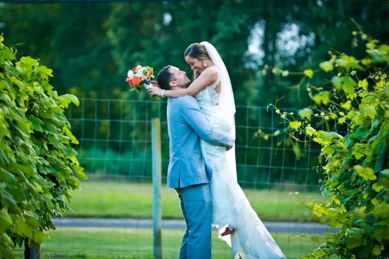 groom holding bride in air